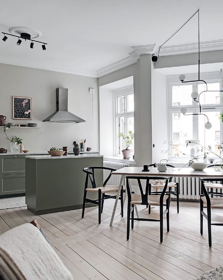 Scandinavian apartment with an olive green kitchen