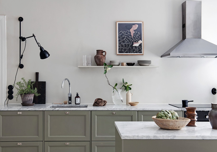 Scandinavian apartment with an olive green kitchen